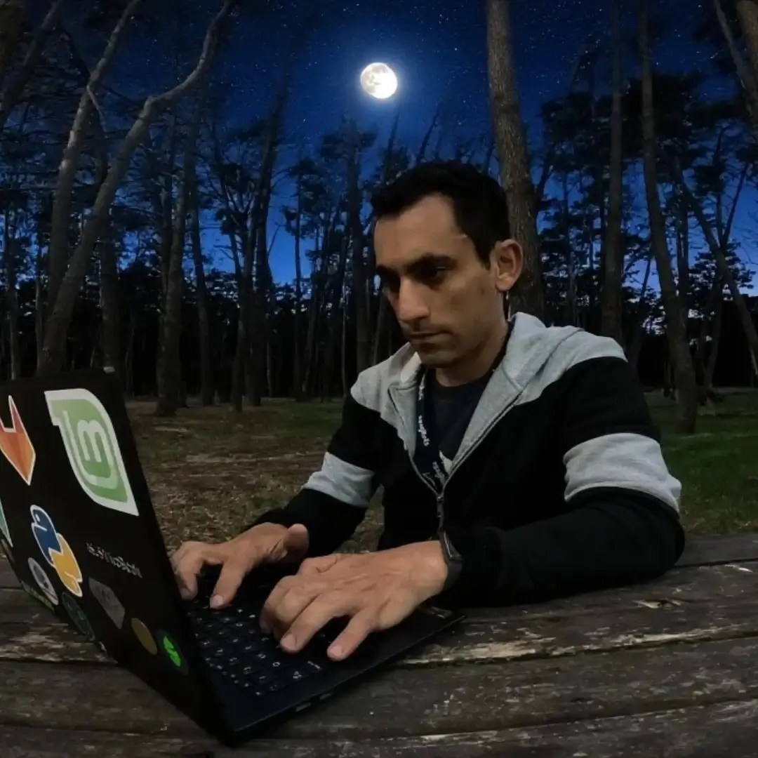 Seba working on his laptop in the forest during the day
