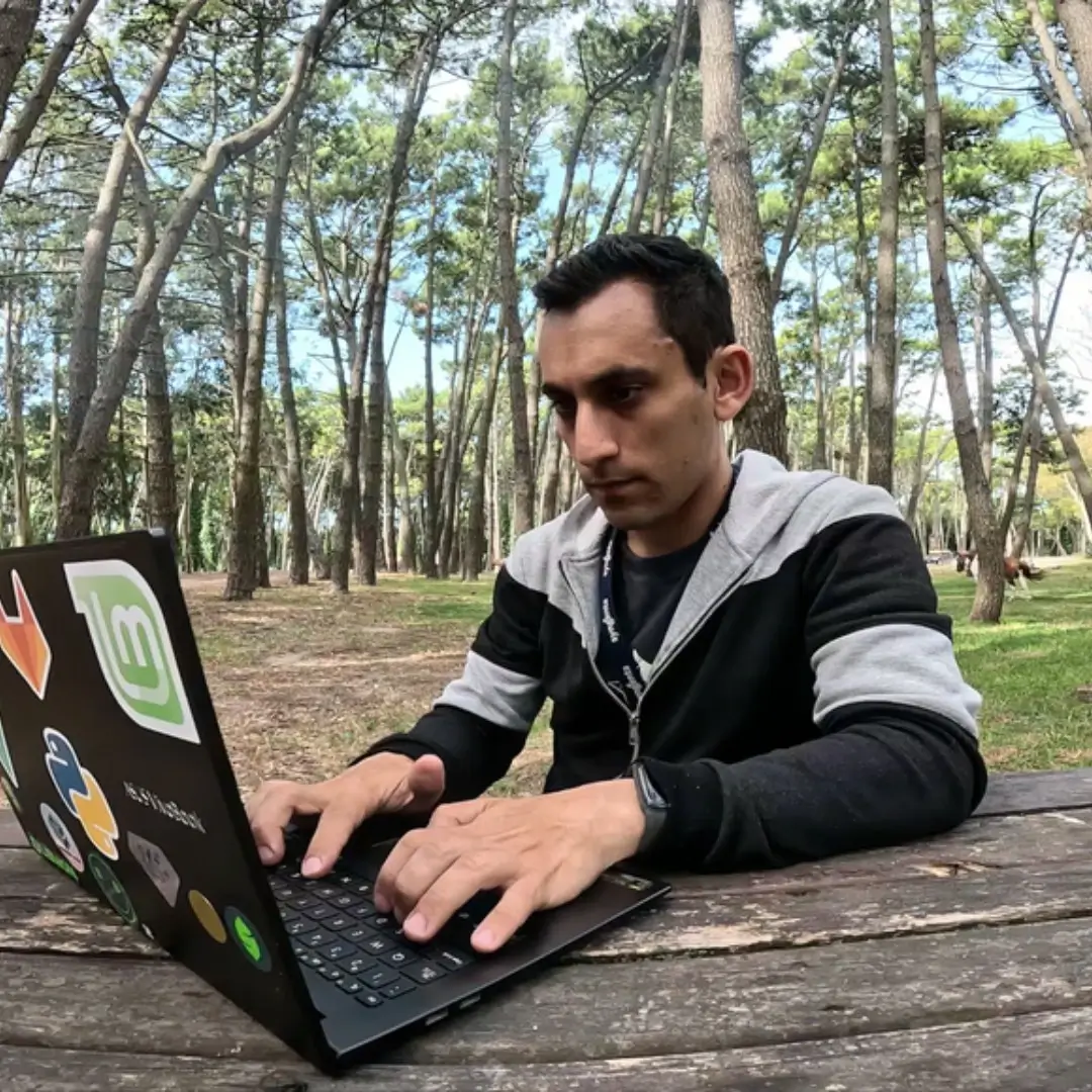 Seba working on his laptop outdoors under the stars